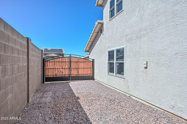 10806 W Adam Ave, Peoria, AZ 85373 - view of home's exterior featuring a gate and stucco siding
