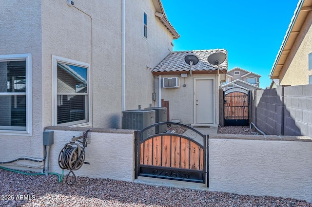 10806 W Adam Ave, Peoria, AZ 85373 - view of property exterior featuring a gate, a fenced front yard, stucco siding, and a tiled roof
