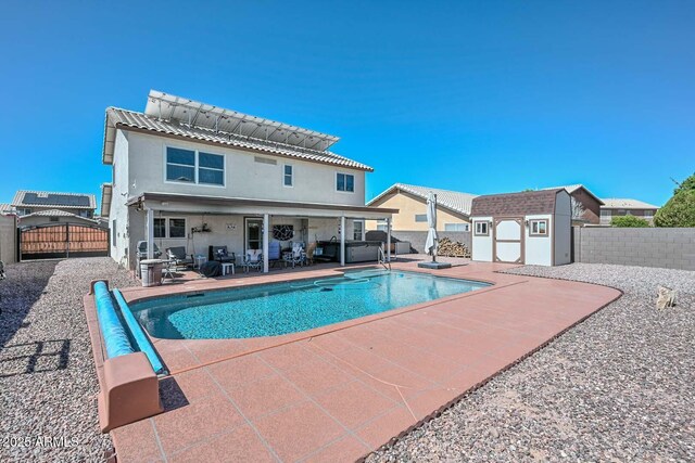 10806 W Adam Ave, Peoria, AZ 85373 - view of swimming pool featuring a shed, a fenced backyard, a patio, and a gate