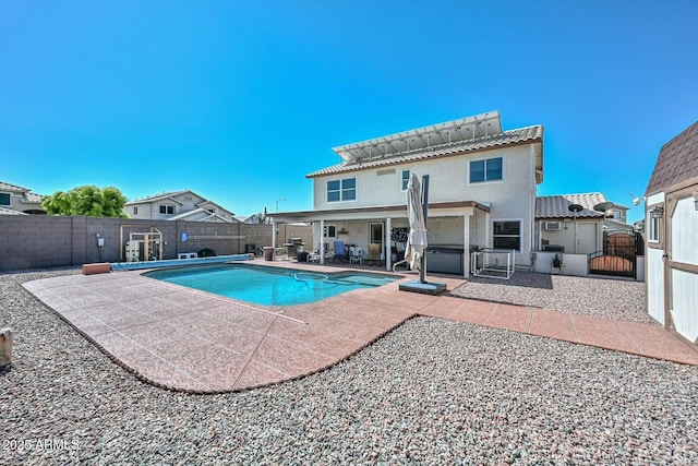 10806 W Adam Ave, Peoria, AZ 85373 - view of swimming pool featuring a fenced backyard, a patio area, a gate, and a jacuzzi