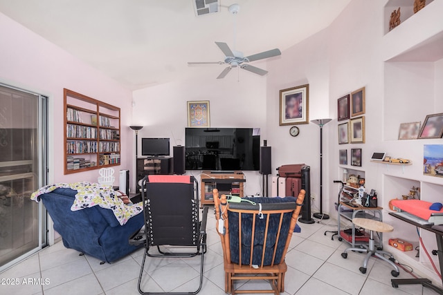 living room featuring ceiling fan, vaulted ceiling, and light tile patterned floors