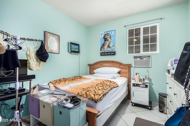 bedroom featuring a wall unit AC and light tile patterned floors