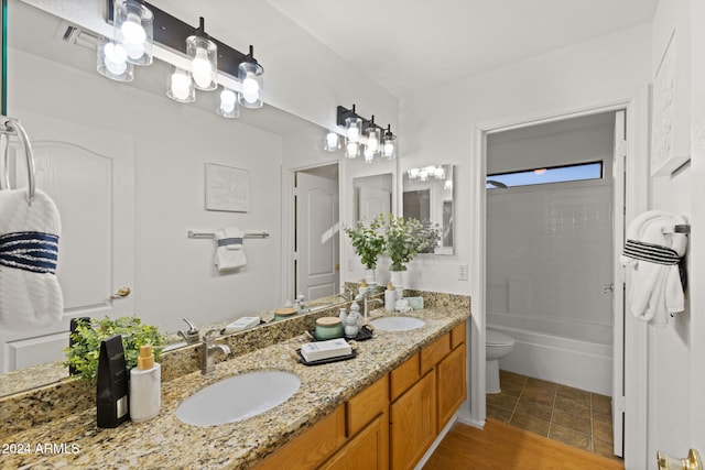 full bathroom with washtub / shower combination, wood-type flooring, vanity, and toilet