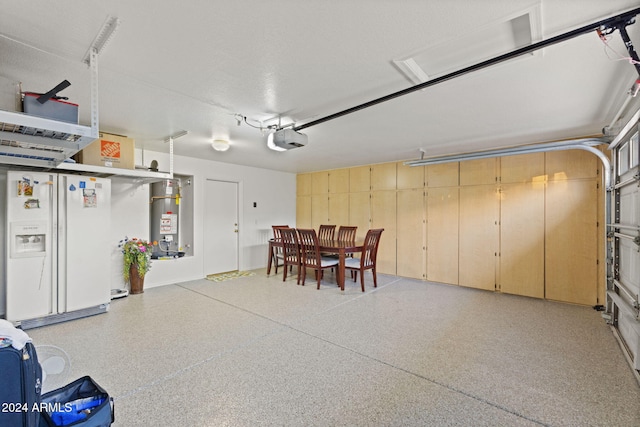 garage with white refrigerator with ice dispenser, gas water heater, and a garage door opener