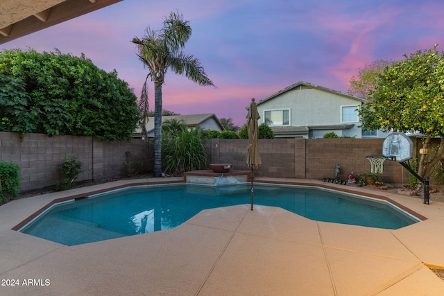 view of pool at dusk