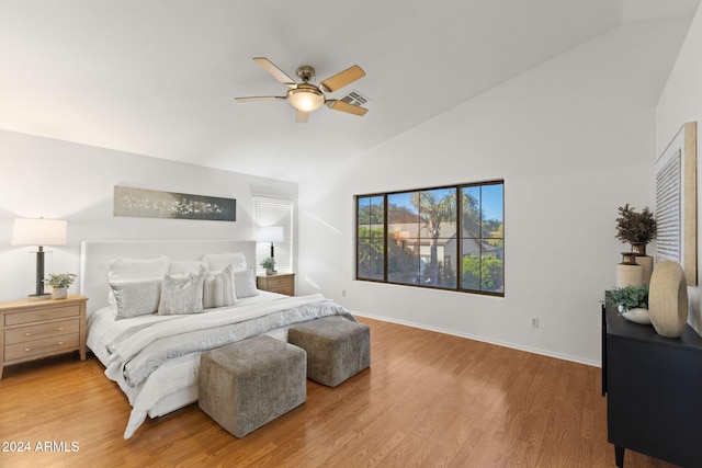 bedroom with ceiling fan, vaulted ceiling, and light hardwood / wood-style flooring