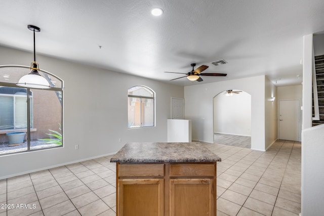 kitchen featuring visible vents, a ceiling fan, light tile patterned flooring, and hanging light fixtures