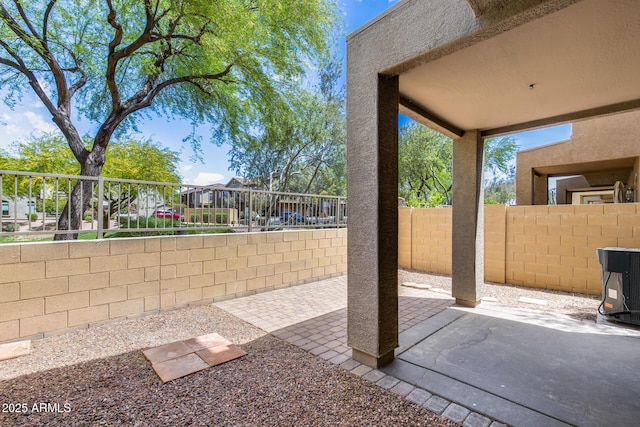 view of patio / terrace with central AC and fence