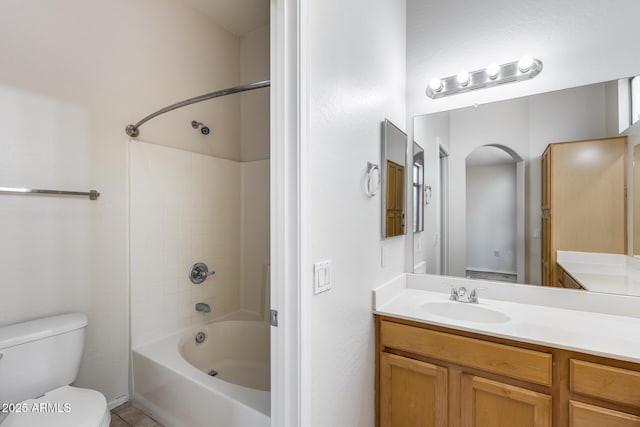 bathroom featuring vanity, shower / bathtub combination, and toilet