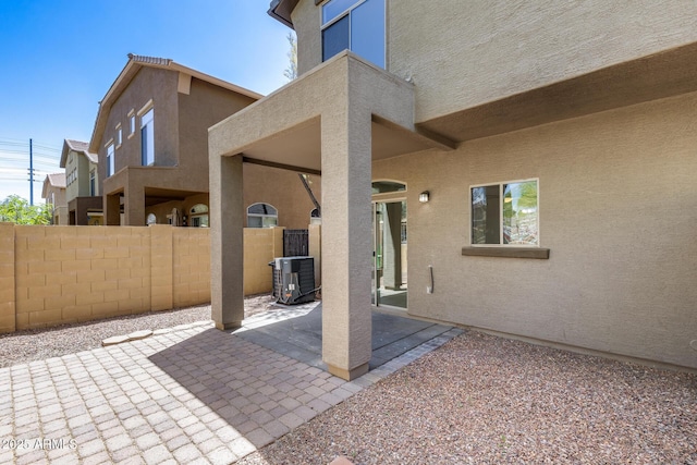 view of patio with fence and cooling unit