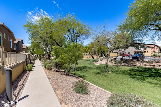 surrounding community with a residential view and a lawn