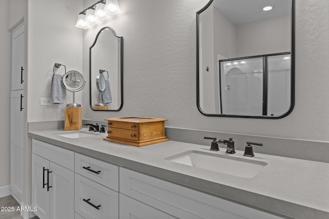 bathroom featuring vanity and a shower with shower door