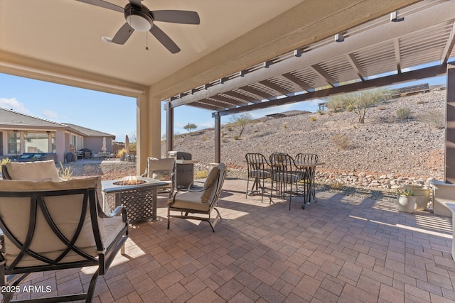 view of patio featuring a pergola, ceiling fan, and an outdoor fire pit