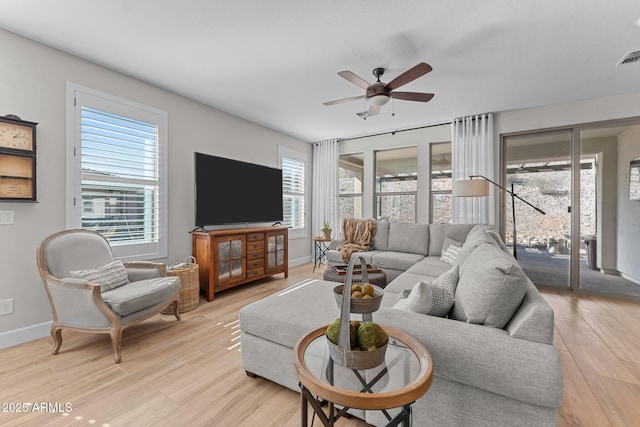 living room featuring ceiling fan and light hardwood / wood-style floors