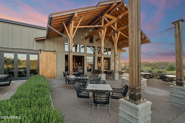 patio terrace at dusk featuring french doors