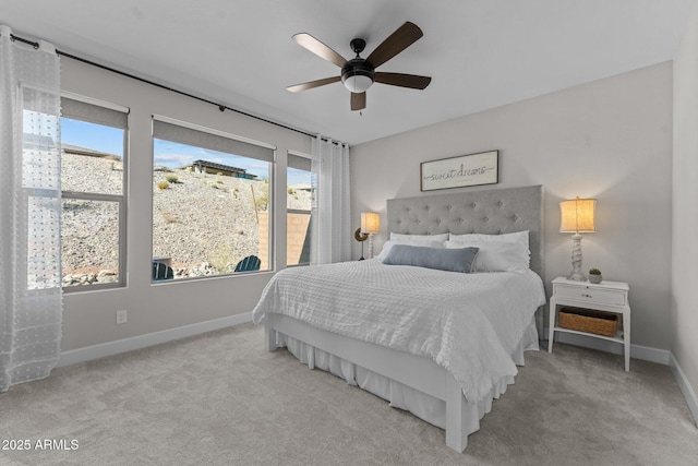 bedroom featuring light colored carpet and ceiling fan