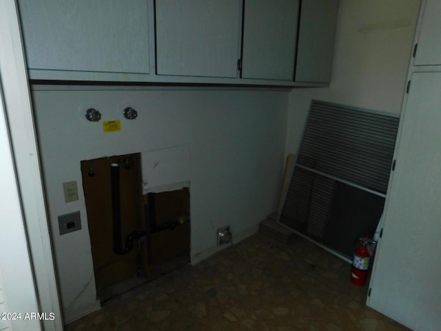 washroom with hookup for an electric dryer and cabinets