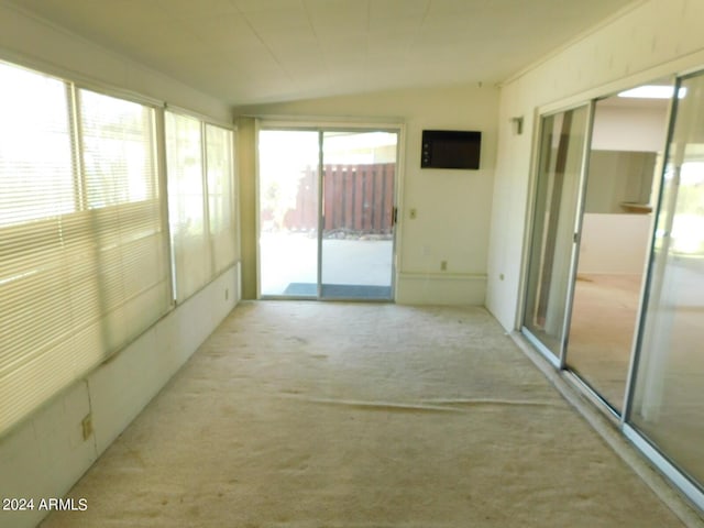 unfurnished sunroom with lofted ceiling