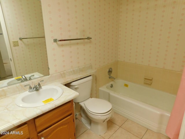 bathroom featuring tile patterned floors, a washtub, vanity, and toilet