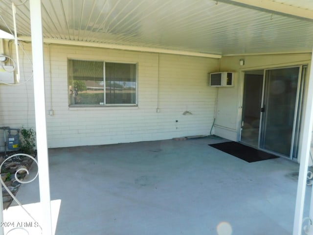 view of patio with an AC wall unit