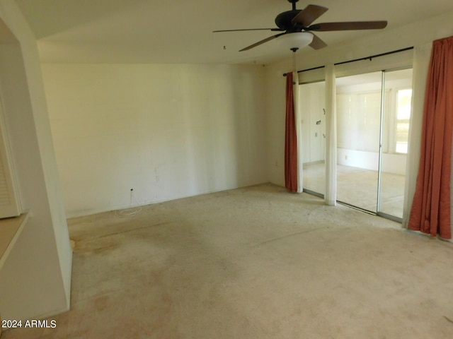 unfurnished bedroom with ceiling fan and light colored carpet