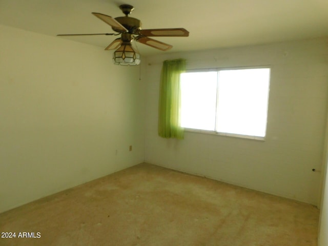 empty room with ceiling fan and light colored carpet