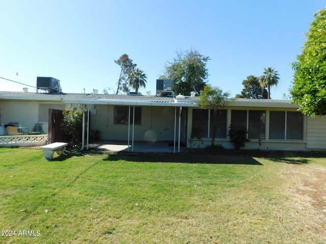 back of house featuring a patio area, a yard, and central air condition unit