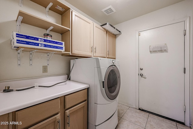 clothes washing area featuring cabinets and light tile patterned flooring