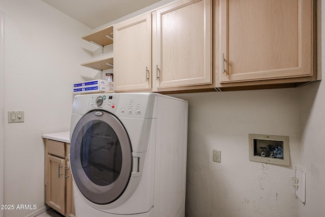 washroom with washer / dryer and cabinets