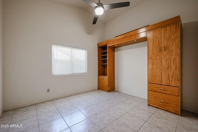 unfurnished bedroom with light tile patterned floors and ceiling fan