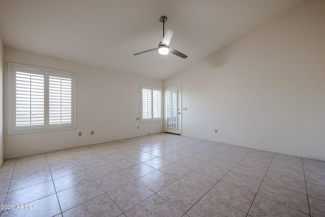 tiled empty room with ceiling fan and lofted ceiling