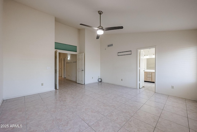 tiled spare room with high vaulted ceiling and ceiling fan