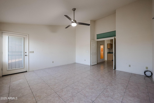 tiled spare room featuring high vaulted ceiling and ceiling fan