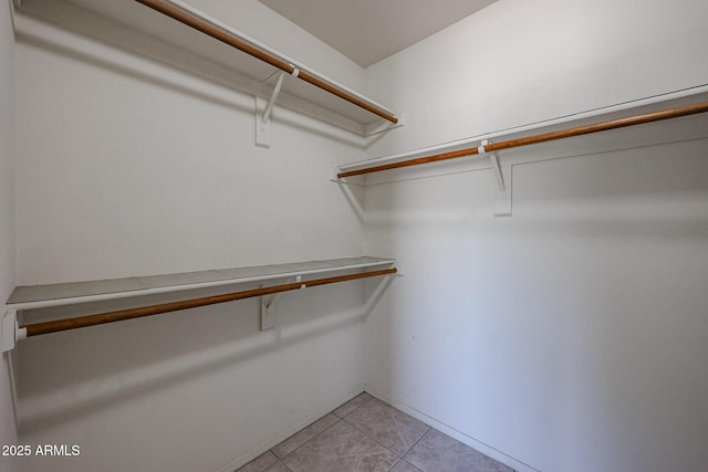 spacious closet featuring light tile patterned floors