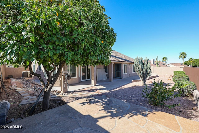 rear view of house with cooling unit and a patio area