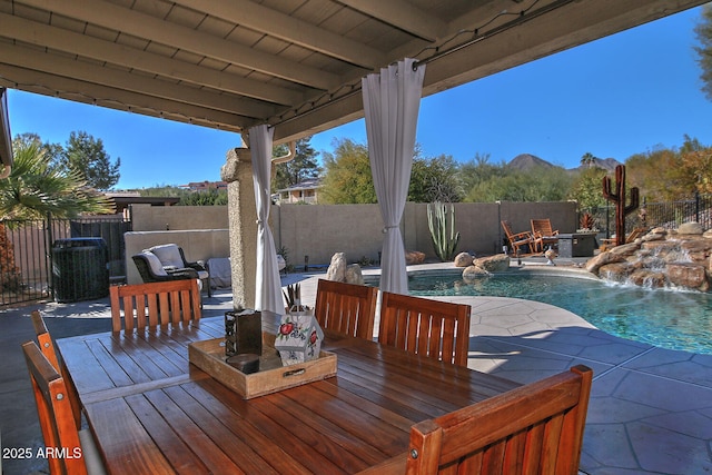 deck with pool water feature, a fenced in pool, a patio, and central AC