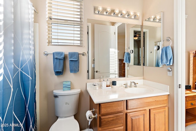 bathroom with a shower with curtain, vanity, and toilet