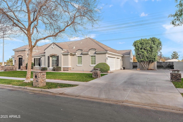 view of front of house with driveway, stucco siding, an attached garage, a gate, and a front yard