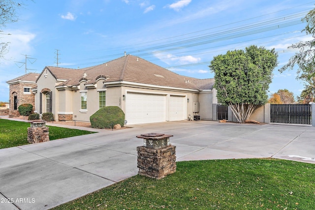 view of front facade featuring a gate, driveway, an attached garage, and stucco siding