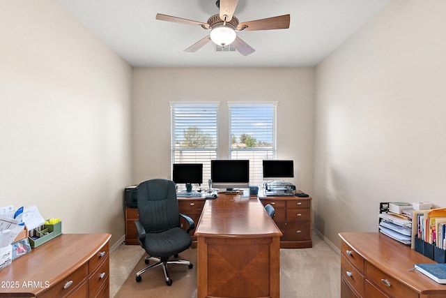 home office with light carpet, baseboards, and a ceiling fan