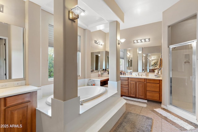 bathroom featuring a stall shower, vanity, a garden tub, and tile patterned floors