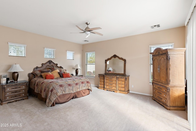 bedroom featuring baseboards, visible vents, a ceiling fan, and light colored carpet