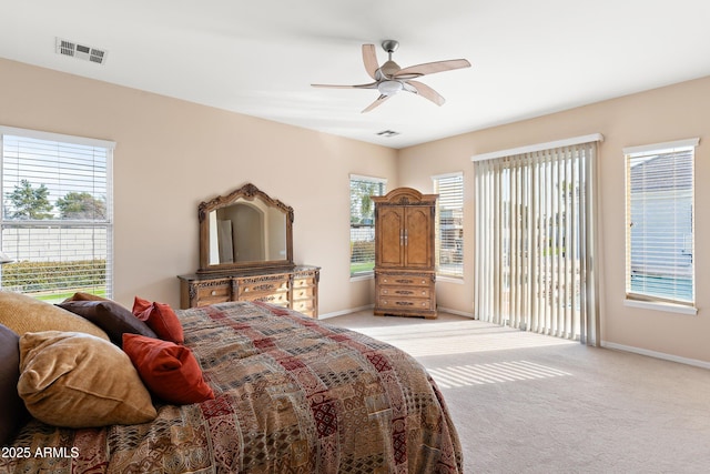 bedroom featuring light carpet, access to outside, multiple windows, and visible vents