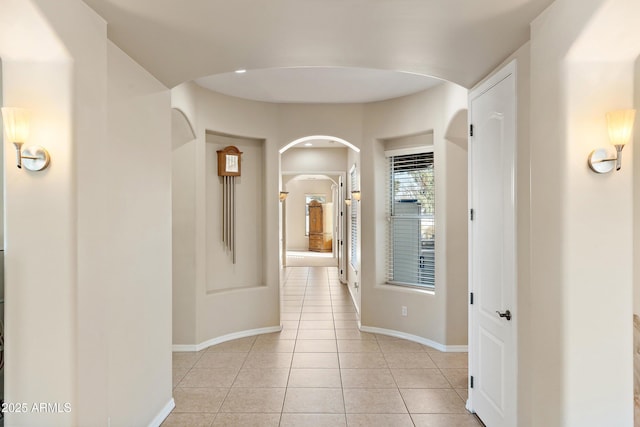 hall with light tile patterned floors and baseboards