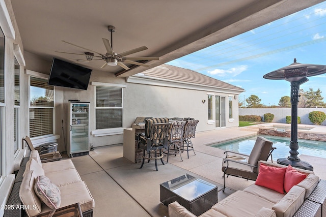 view of patio / terrace featuring a pool with connected hot tub, fence, an outdoor living space, and a ceiling fan