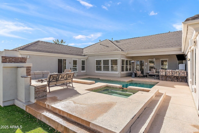 rear view of house featuring an outdoor hangout area, a patio area, a tile roof, and stucco siding