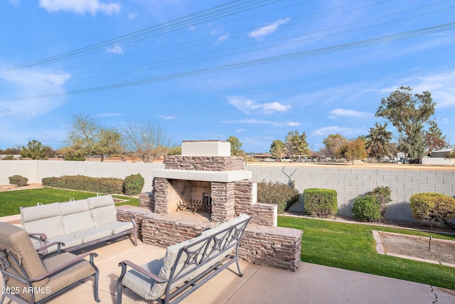 view of patio / terrace with a fenced backyard and an outdoor living space with a fireplace