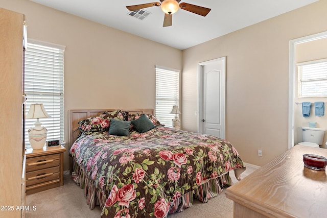 bedroom featuring light carpet, ceiling fan, and visible vents