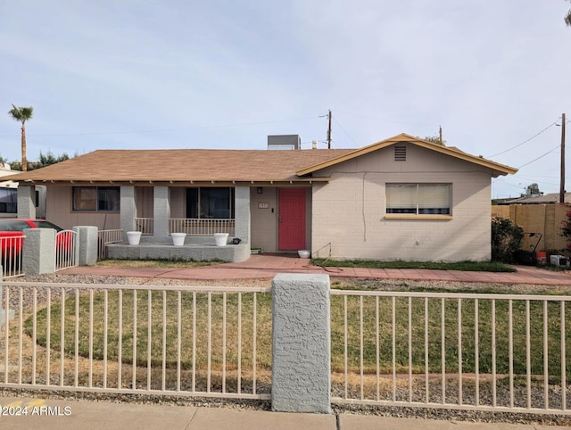 single story home with a front yard and a porch