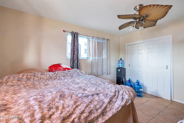 tiled bedroom with a closet and ceiling fan